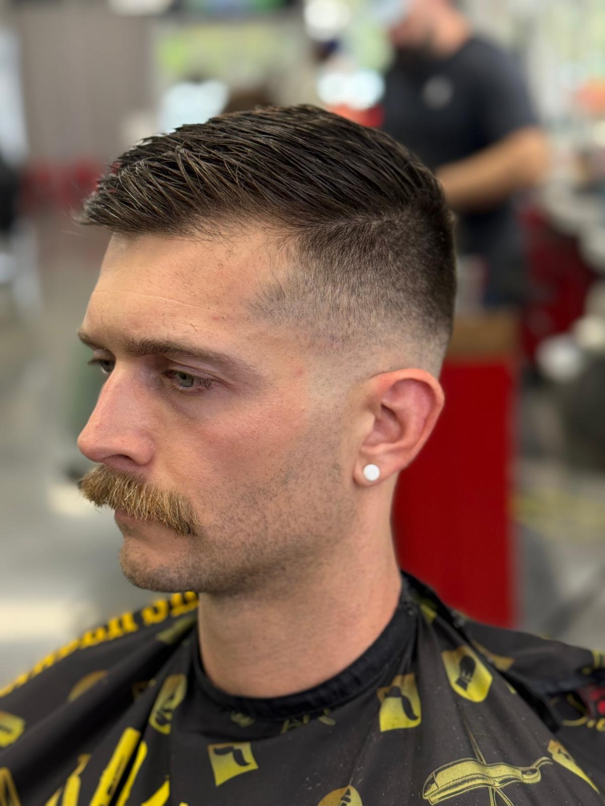 Barber working carefully on a client